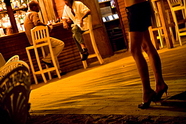 A woman's high heeled legs in a beach bar in the Dominican Republic