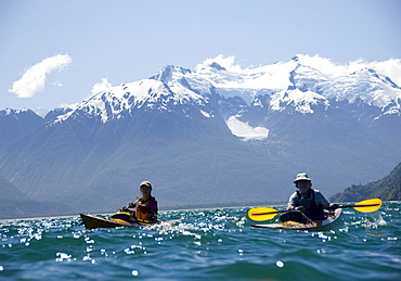 Two people kayak in Lago Yelcho, Chile