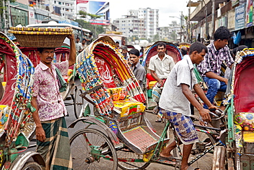 Dhaka,  Bangladesh - July 2011: Street traffic in Dhaka.  With over 400, 000 rickshaws running the streets on Dhaka every day the Bangladeshi capital has been described as the "Rickshaw capital of the world.