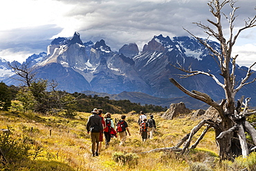 TORRES DEL PAINE NATIONAL PARK, PATAGONIA, CHILE. Hikers enjoy one of the best national parks in South America on a sunny day. With steep peaks full of hanging glaciers and glacial silt-filled lakes, Torres del Paine is one of the greatest attractions on Earth.