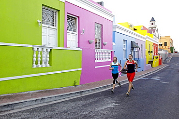 Katrin Schneider and Susann Scheller running trough the streets of the very colorful Bo-Kaap or Capa Malay Quarter of Cape Town. South Africa.