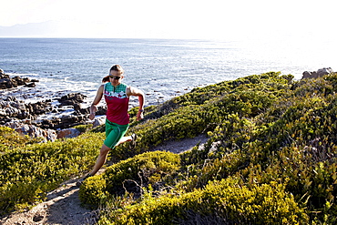 Susann Scheller running on an ocean trail between Gansbaai and De Kelders. South Africa.