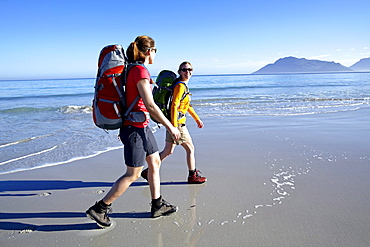 Katrin Schneider and Susann Scheller hiking along Nordhoek Beach while beeing on the Hoerikwaggo Trail from Cape Point to Table Mountain in Cape Town. South Africa.