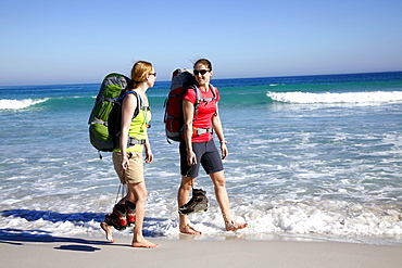 Katrin Schneider and Susann Scheller hiking along Nordhoek Beach while beeing on the Hoerikwaggo Trail from Cape Point to Table Mountain in Cape Town. South Africa.