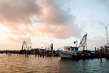 ROCKPORT, TEXAS, USA. Boats moored at sunset near a small coastal town.