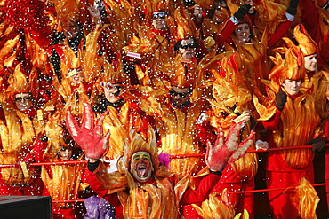 Masks and caricatures of politicians singing and dancing in the streets and enormous paper mache floats, surrounded by thousands of people, in the great celebration of the Carnival of Viareggio.