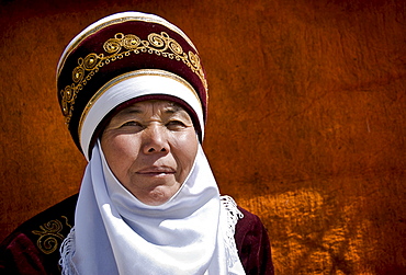 Local Kyrgyz Woman wearing traditional dress. Bokonbayebo, Kyrgyzstan