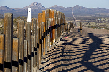 The new post & rail border fence runs next to the original border markers, Arizona.