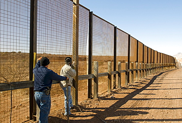 Welders repair the pedestrian border fence with Mexico, AZ.