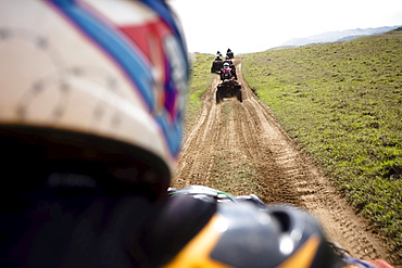 A group of man rides their quads through a dirt road from Catemaco to Coatzacoalcos in Veracruz, Mexico.