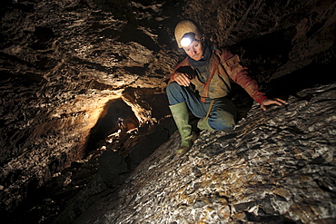 A man admires rock patterns underground in a cave in China.