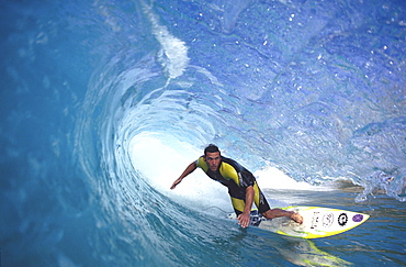 A man surfs under a curling wave at Whale Beach, Sydney.