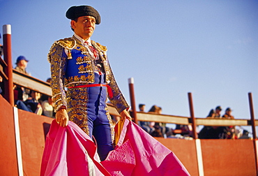 A matador waits for his bull to enter the ring.