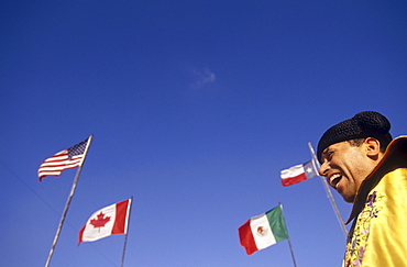 Matador stands underneath the flags of USA, Canada, Mexico and the State of Texas before the start of a bullfight.