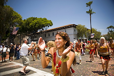 Revelry and happiness at a parade in Santa Barbara. The parade features extravagant floats and costumes.