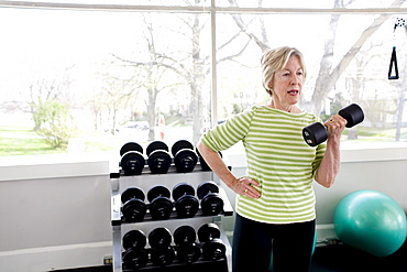 Older woman exercising in a gym.