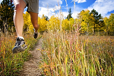 a woman trail running near gold hill, co.