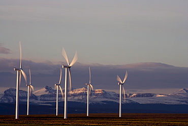 Wind turbines and the High Uinta Mountains at a wind farm in Southern Wyoming.