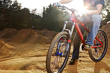 A man resting after riding his mountain bike.