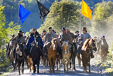 Chilean indigenous Mapuche communities cavalcade on horseback for their land and water resources in the Reigolil Valley of Chile.