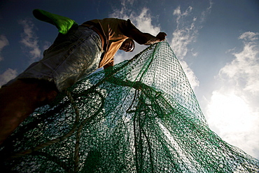 A fisherman straightens nets on the docks of Joshua's Marina in Buras, Louisiana.