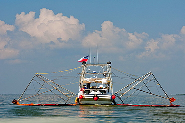 Commercial fishing boats have been converted to oil cleanup crews as part of the "vessels of opportunity" program managed by BP.