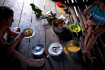 Oro Win people eat a meal of fish stew and farinha, Sao Luis Indian Post, Brazil.