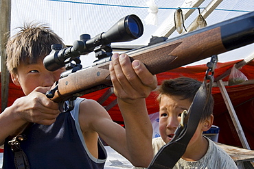 Children from a foster home in Nuuk, Greenland learning about hunting at their summer camp.