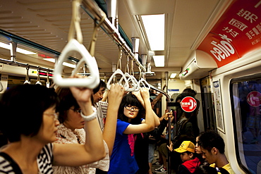 A teenage girl rides the MRT in Taipei, Taiwan, October 23, 2010.