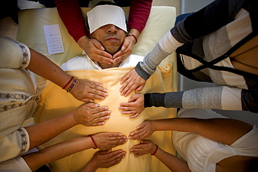 A man receives Reiki by a group of students in Mexico City