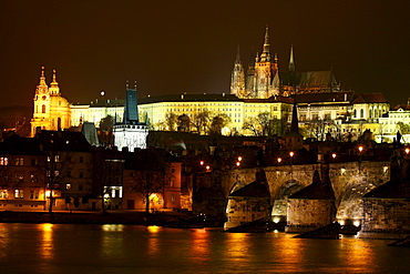 A view of an evening Prague cityscape from the The Charles Bridge over the Vitava River in the Czech Republic