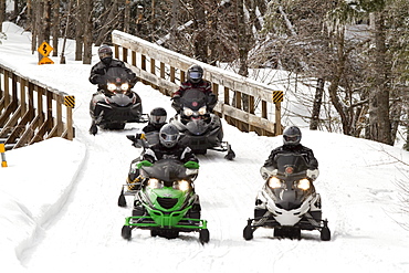 Snowmobilers sled near the Presidential Range in Bretton Woods, NH.