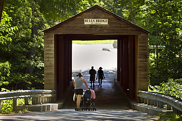 Visitors at a covered bridge in New England.