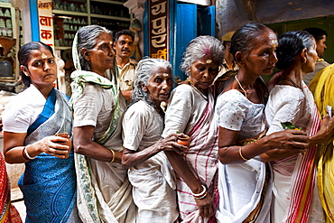 Woman pilgrims outside a temple, Varanasi, India.