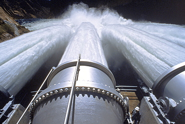 The jet tubes on Glen Canyon Dam the day they were opened for the controlled flood of 45,000 cfs on the Colorado River. Acting Facility Manager Dick White checks the jet tubes.