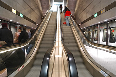 Commuters ride the escalator and board subway trains in Copenhagen, Denmark. Scandinavia.