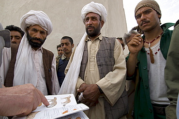 Conservation biologist George Schaller asks local shepherds and policemen  about leopards and cheetah, at a border post on the border with Iran, in Gulran District, in the northwest part of Herat Province.   Dr. Schaller was making a wildlife survey to see what remained of biodiversity in the Northwest corner of Afghanistan, and interviewed soldiers, shepherds and other Afghans who move through the region to find out what wildlife they had seen.