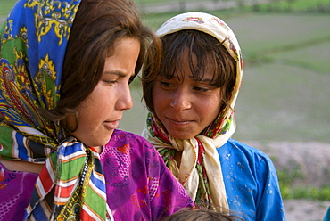 Two young girls share a secret in the Tajik village of Dera Jawal, at the base of the Band-e Baba range,  Herat Province, Afghanistan