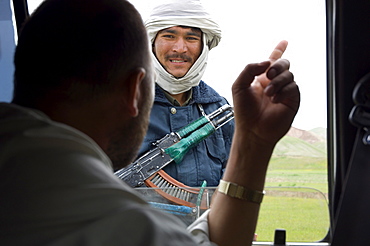 A  Herati man asks for directions from a border policeman near the Turkmenistan border in, Kushk-i Kuhna district, Herat Province, Afghanistan