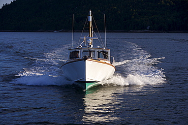 A Stanley designed Downeaster, a classic Maine fishing boat, motors in Sommes Sound, Mt. Desert Island, Maine.  Mt Desert Island is the home of Acadia National Park