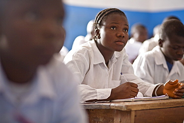 Young Liberian girl writing at his desk in a classroom in a public school in then northern Liberian town of Voinjama in Lofa County.