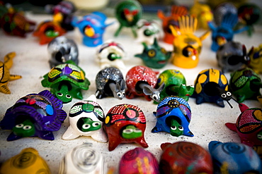 Close-up of small carved wooden turtles on display on Isla Mujeres, Mexico.