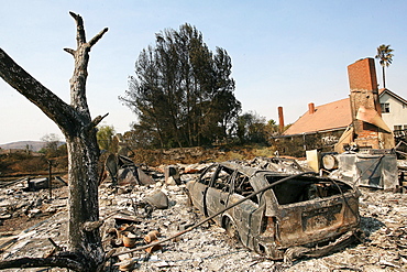 Charred remains of homes which were burned to the ground stand in a neighborhood of Rancho Bernardo in San Diego during the Southern California wildfires of 2007. More than a dozen homes were completely lost in the small neighborhood there.