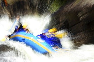 Motion-blur photo of unknown whitewater rafters crashing through Pillow Rock rapid on the Upper Gauley river near Fayetteville, WV