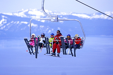 Heavenly Ski Instructor Danielle Ledesma riding the chairlift above Lake Tahoe with her class of young students at Heavenly Mountain Resort in South Lake Tahoe, California.