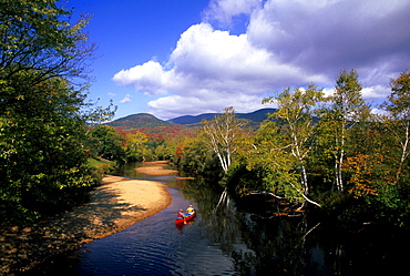 Rob Center and kay Henry paddle their canoe on the Upper Ammonoosuc River in far northern New hampshire on a beautiful autumn day. The river is a part of the Northern Forest Canoe Trail, which was founded by Rob and Kay.