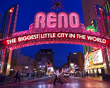 Glittering icon archway advertising ""Reno - The Biggest Little City In the World" at night, leading into the casino quarter in Reno, NV.