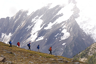 A guided group moves quick over alpine terrain, Canadian Rockies, British Columbia, Canada.