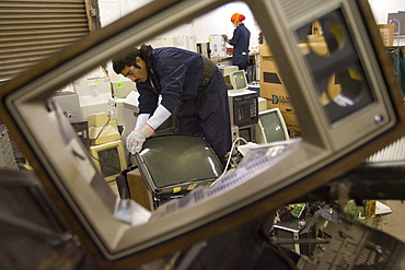 At CRT Recycling in Brockton, Massachusetts, workers look over electronics collected locally to determine what is valuable to recycle in house and what is sent overseas.