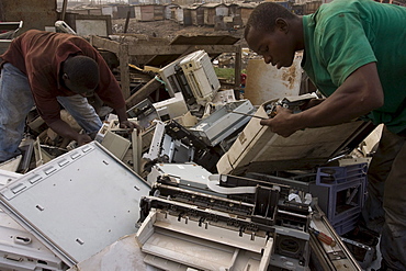 Burning of computer wire and parts to recover copper and other metals in Accra, Ghana. The computers are shipped here from Europe and the USA and some are reused but majority are dumped in Ghana. Poor workers often from the northern poorer region of Ghana do the work and sell the copper to buyers who send the copper to China or India.